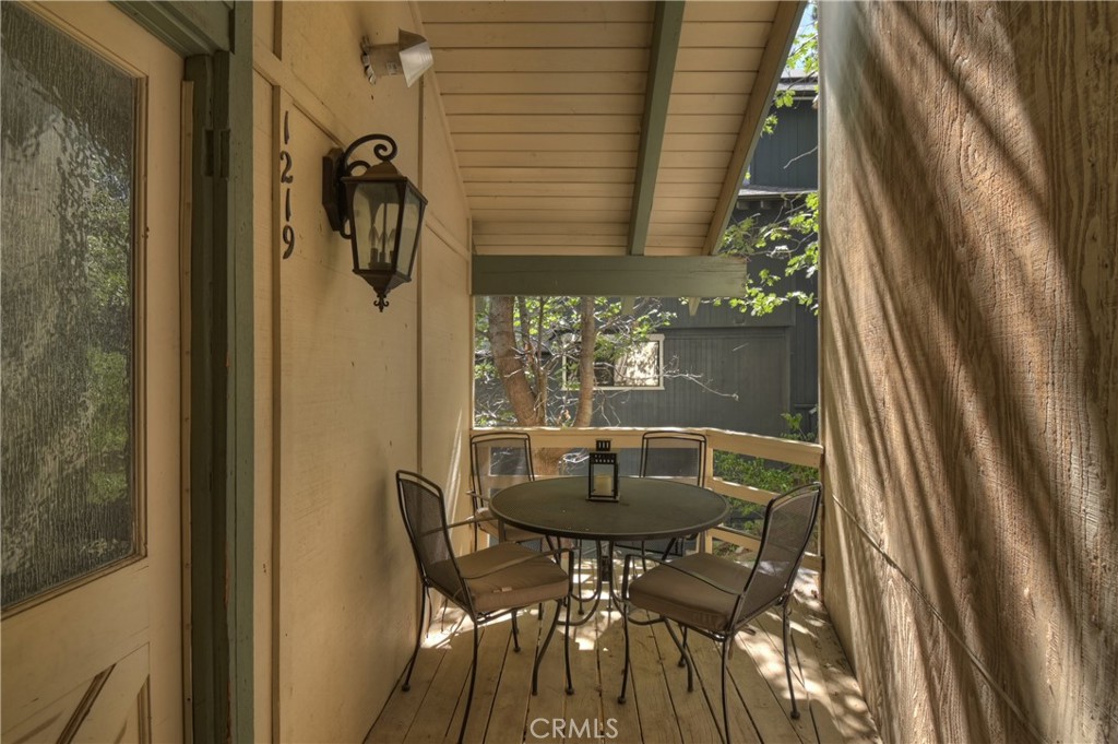 1219 Klondike Drive Lake Arrowhead, CA 92352 - Photo 33 of 37 a view of balcony with a table and chairs