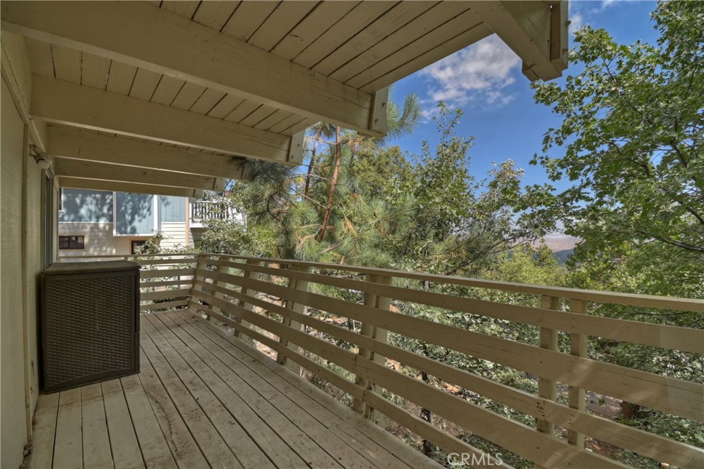 1219 Klondike Drive Lake Arrowhead, CA 92352 - Photo 37 of 37 a view of a balcony with wooden floor and fence