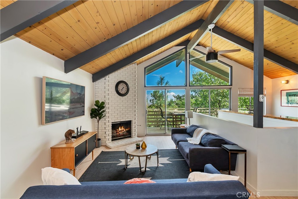 1219 Klondike Drive Lake Arrowhead, CA 92352 - Photo 6 of 37 a living room with fireplace furniture and a large window