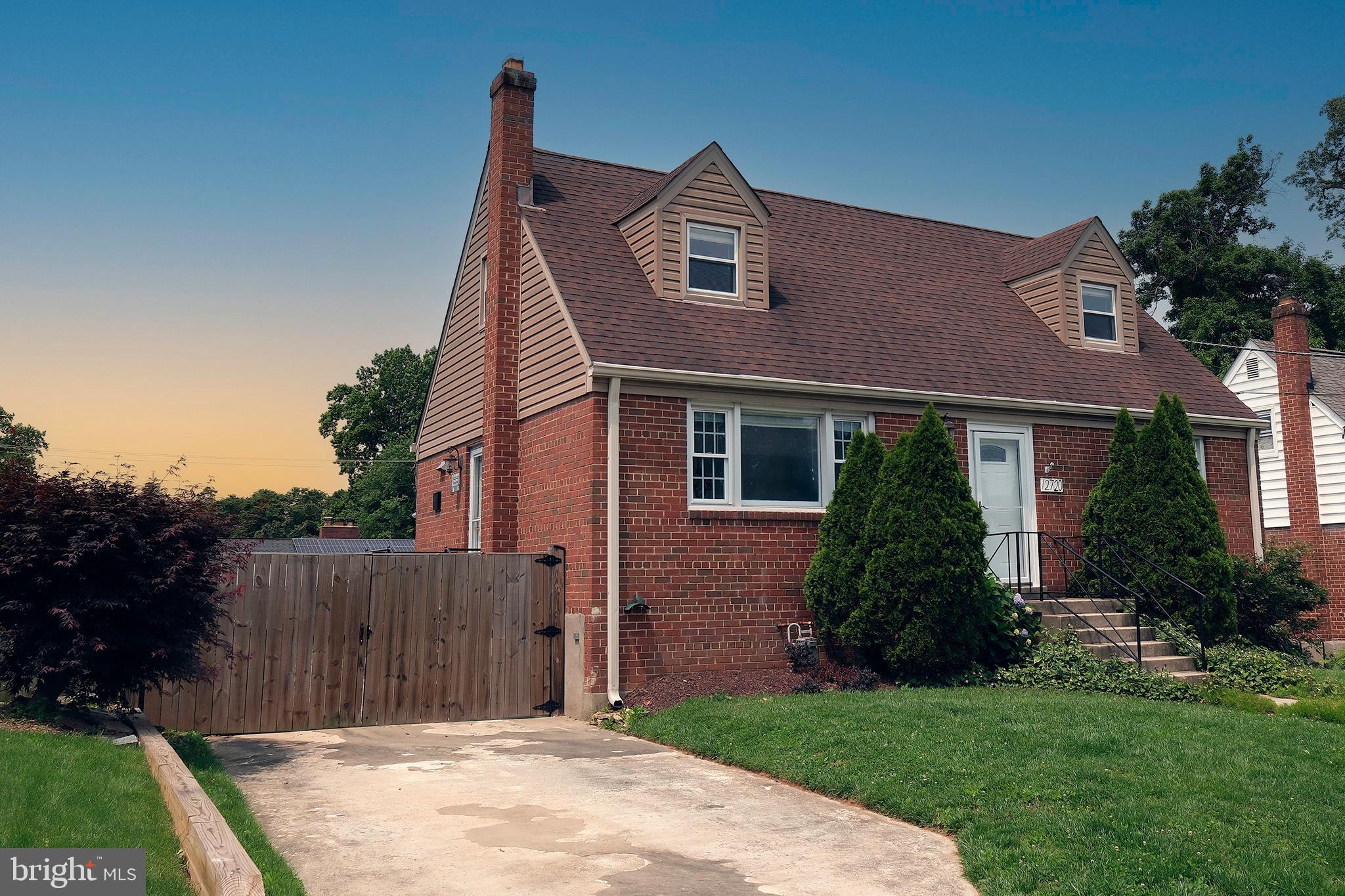 12720 Feldon Street Silver Spring, MD 20906 - Photo 4 of 13 a front view of a house with a garden and plants