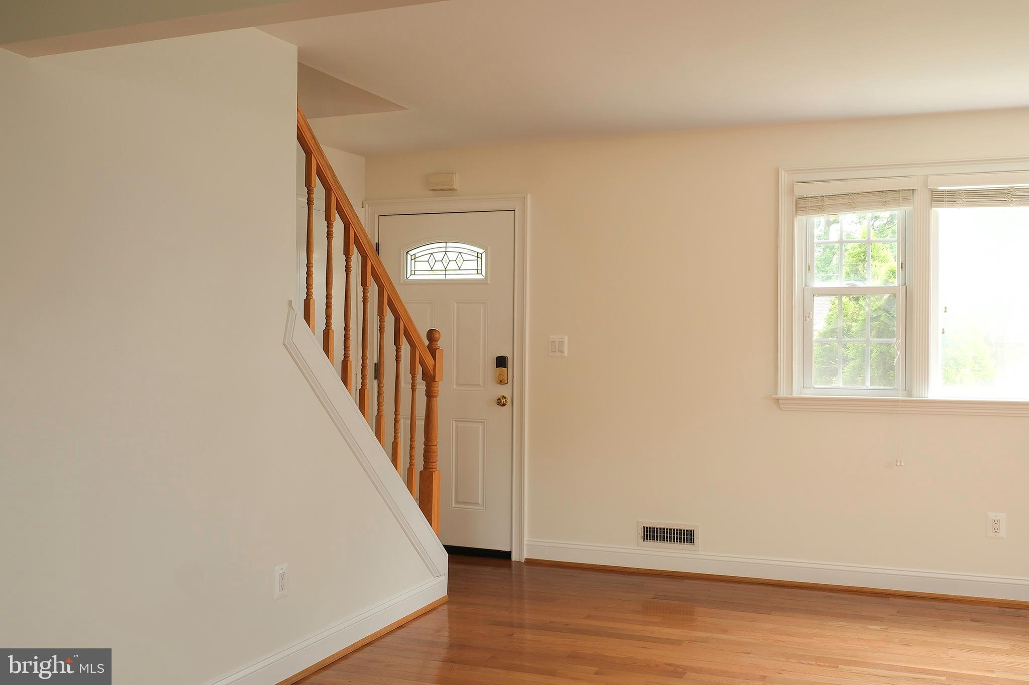 12720 Feldon Street Silver Spring, MD 20906 - Photo 7 of 13 a view of a hallway with wooden floor and entryway