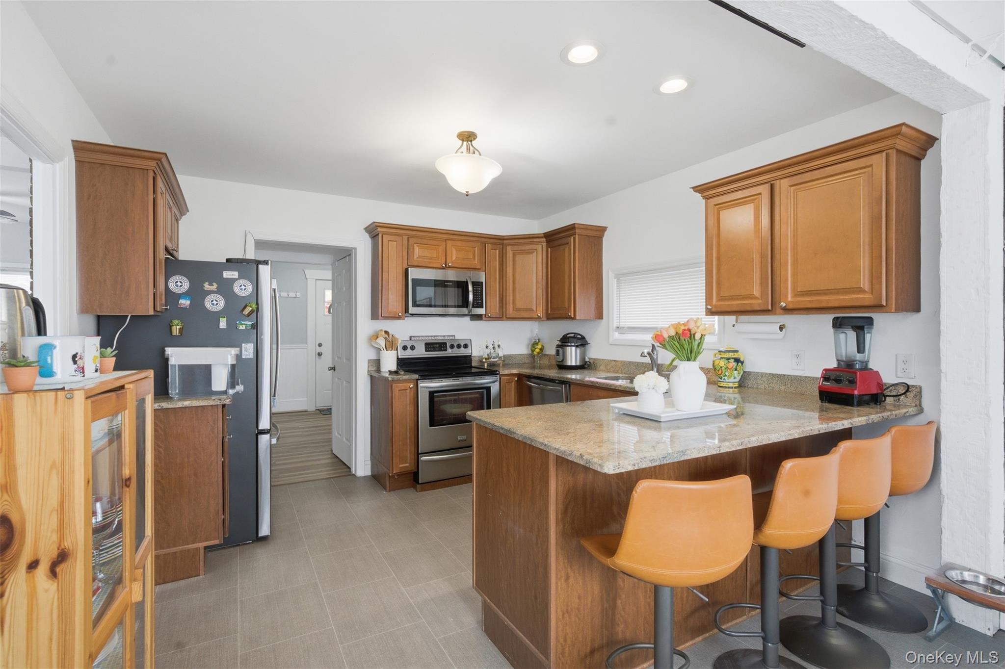 64 Wait Street Walden, NY 12586 - Photo 12 of 26 a kitchen with stainless steel appliances granite countertop a stove refrigerator sink and cabinets