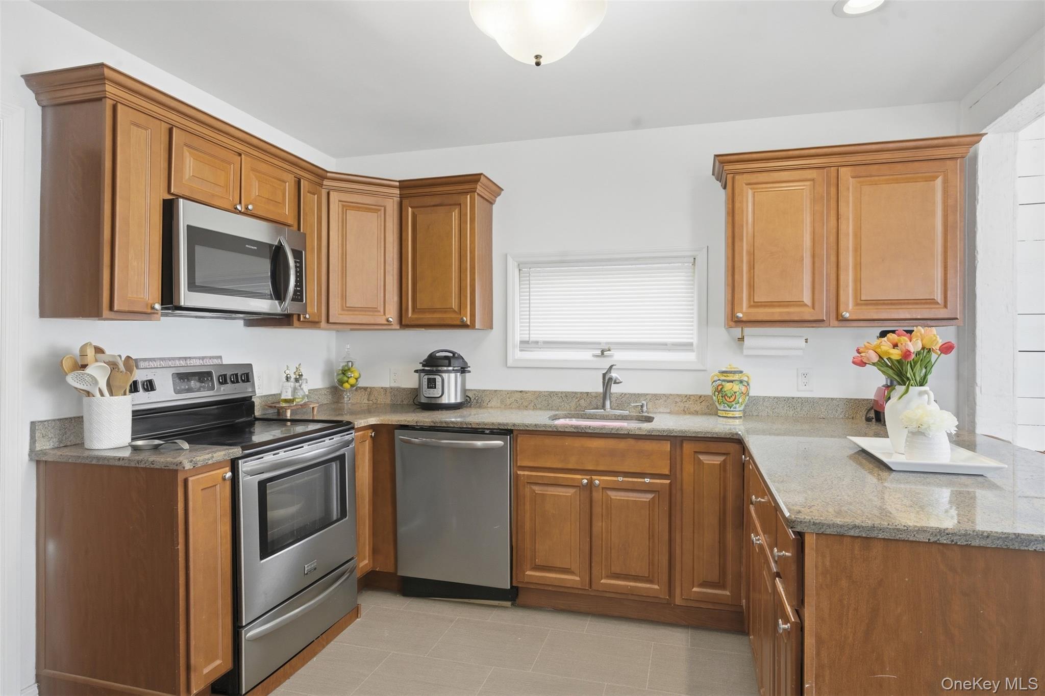 64 Wait Street Walden, NY 12586 - Photo 14 of 26 a kitchen with stainless steel appliances granite countertop a sink stove and cabinets