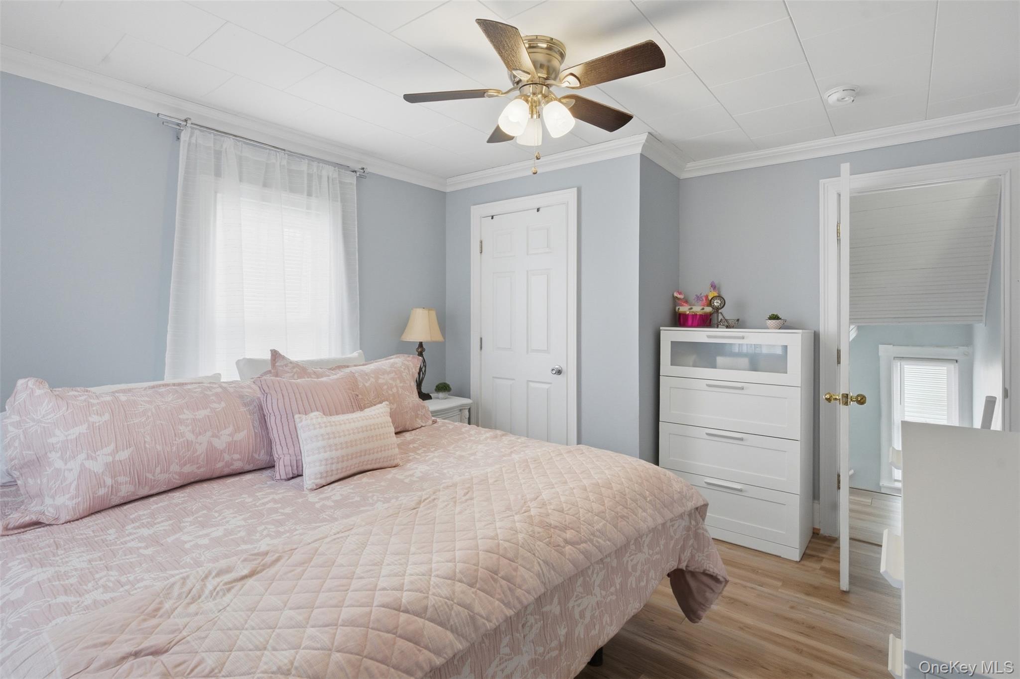 64 Wait Street Walden, NY 12586 - Photo 20 of 26 a bedroom with a bed and a chandelier