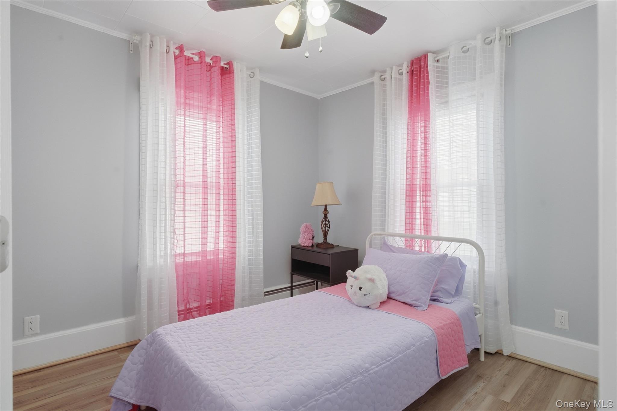 64 Wait Street Walden, NY 12586 - Photo 22 of 26 a bedroom with a bed and a chandelier
