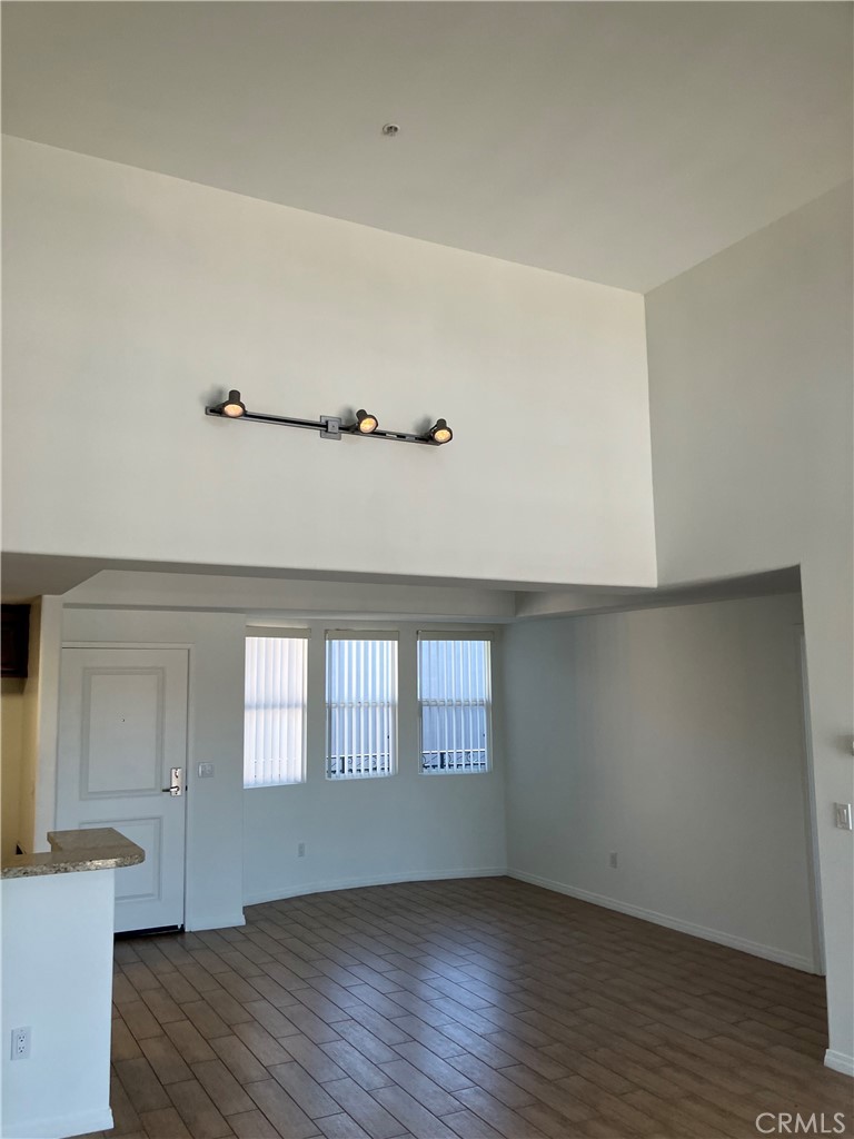 11925 Kling Street, Unit 101 Valley Village, CA 91607 - Photo 15 of 17 an empty room with wooden floor and windows