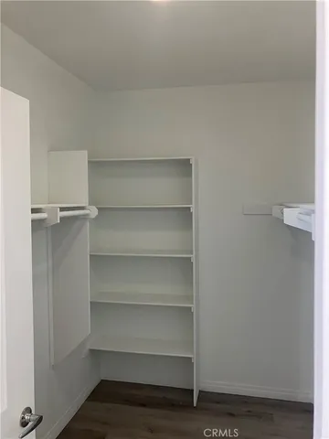 a view of walk in closet with empty racks
