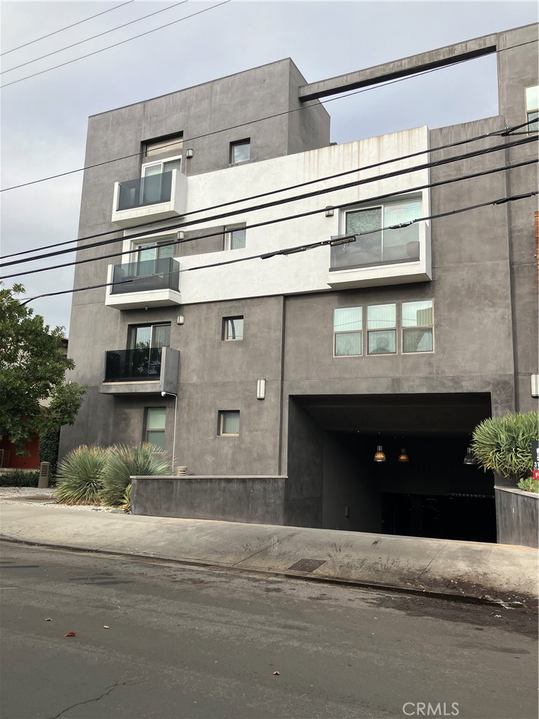 11925 Kling Street, Unit 101 Valley Village, CA 91607 - Photo 10 of 17 a front view of a house with a garage