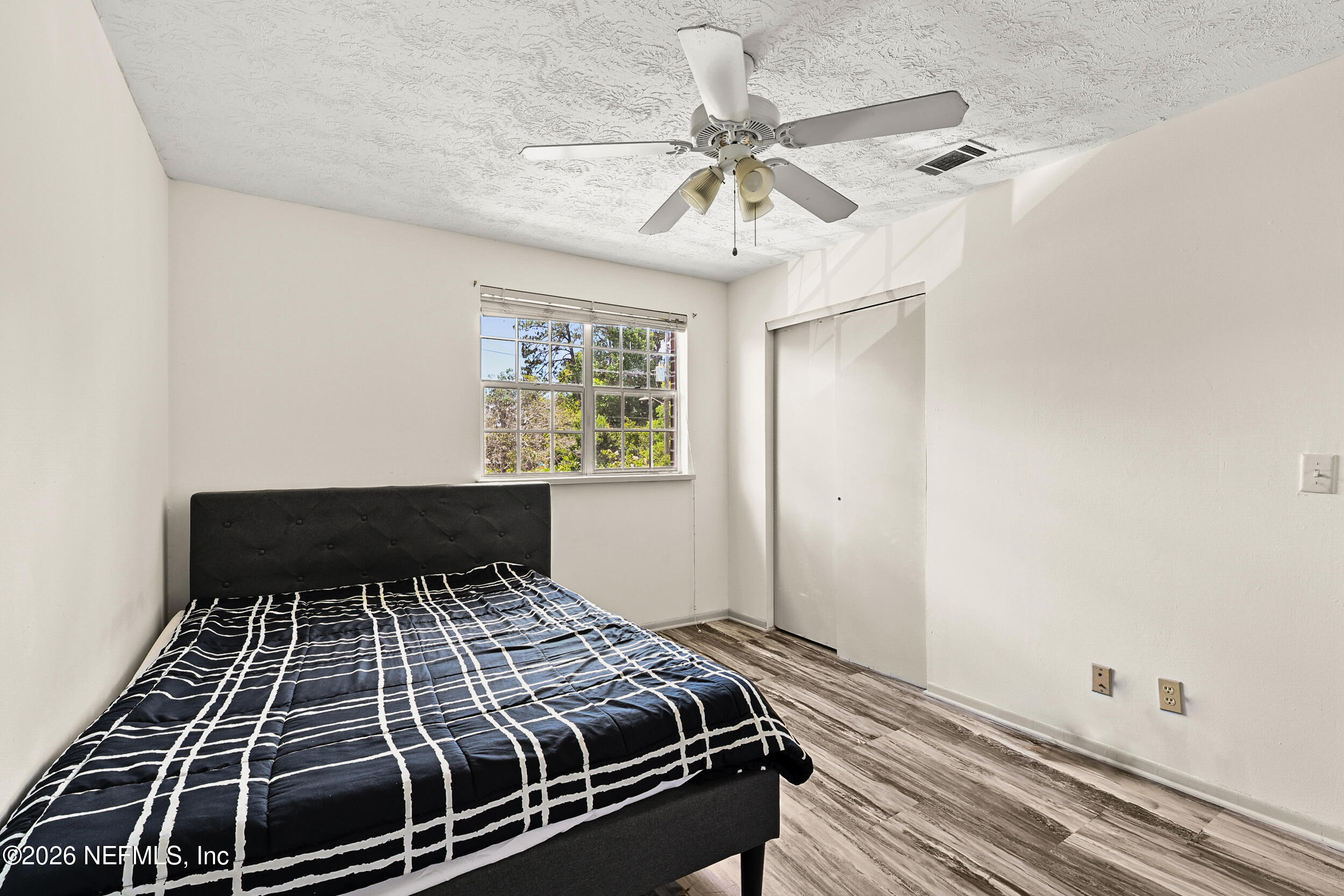 4915 Baymeadows Road, Unit 6G Jacksonville, FL 32217 - Photo 27 of 44 a bedroom with wooden floor and closet
