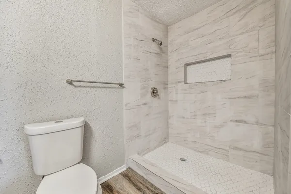 a bathroom with a toilet and shower