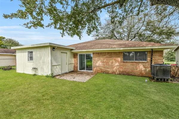 a view of a house with a yard and sitting area