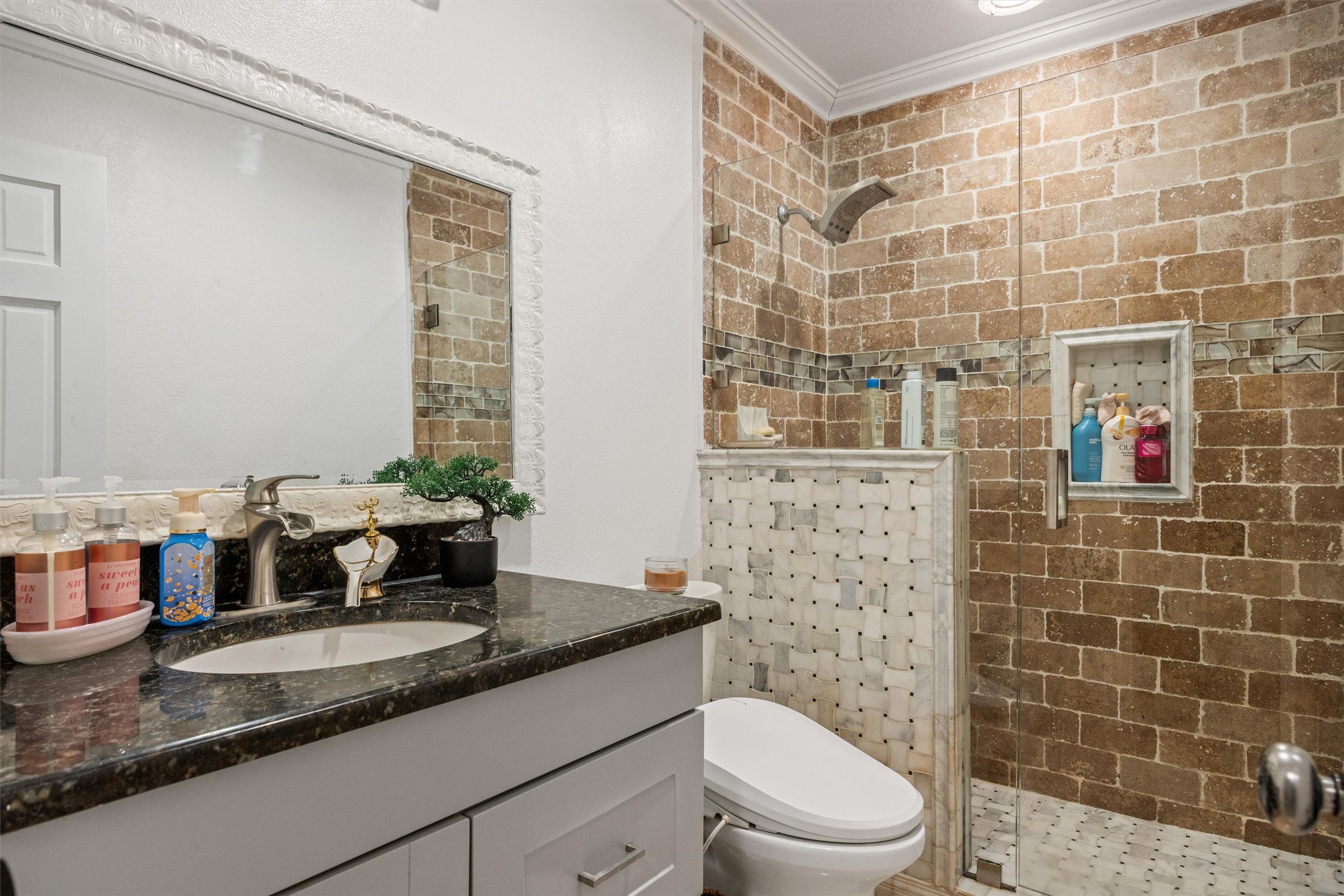 14409 Sandifer Street Austin, TX 78725 - Photo 15 of 31 Full bath with vanity, a shower stall, and crown molding