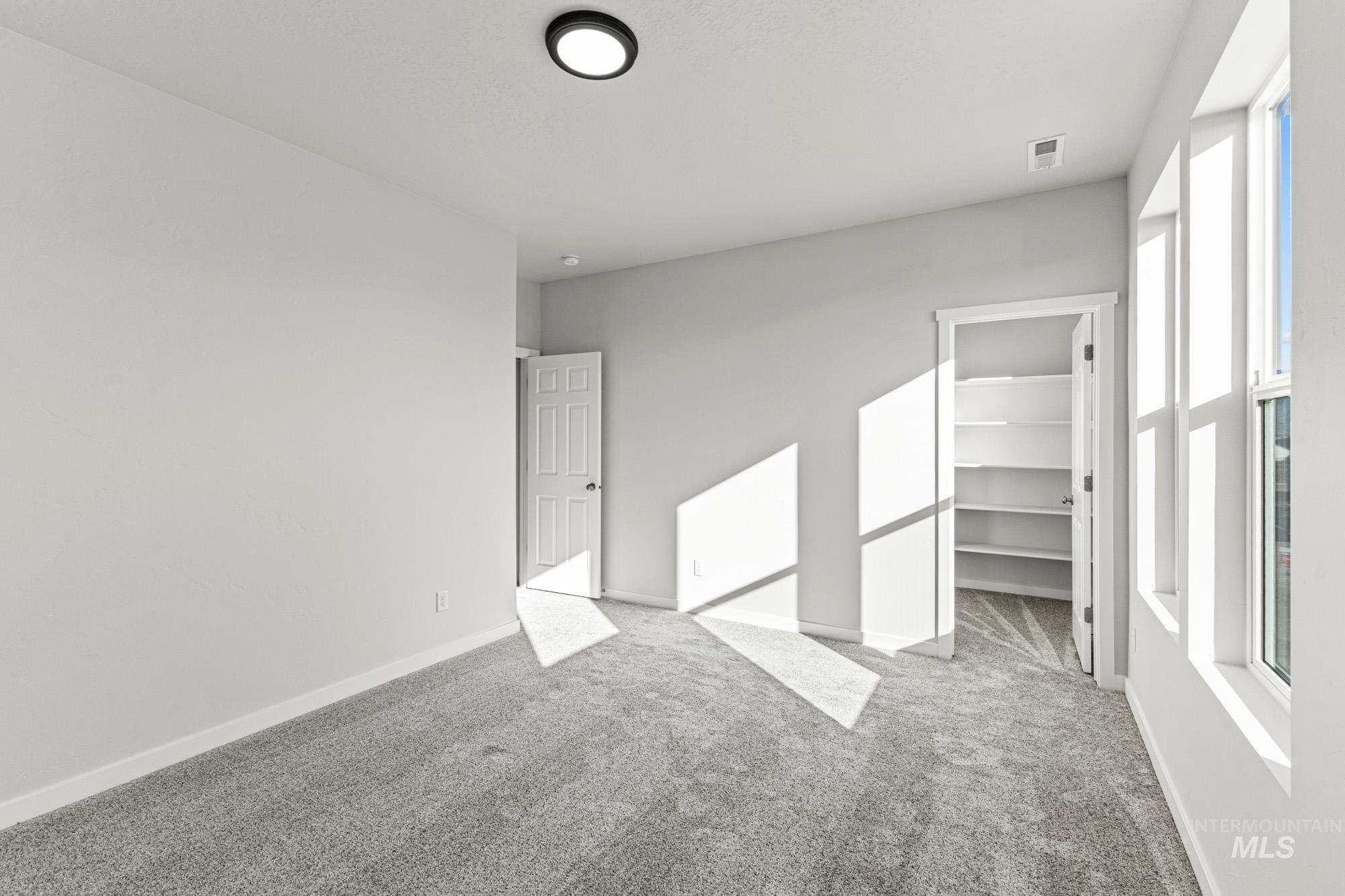 13708 Judson Street Caldwell, ID 83607 - Photo 19 of 29 Unfurnished bedroom featuring a walk in closet and carpet floors
