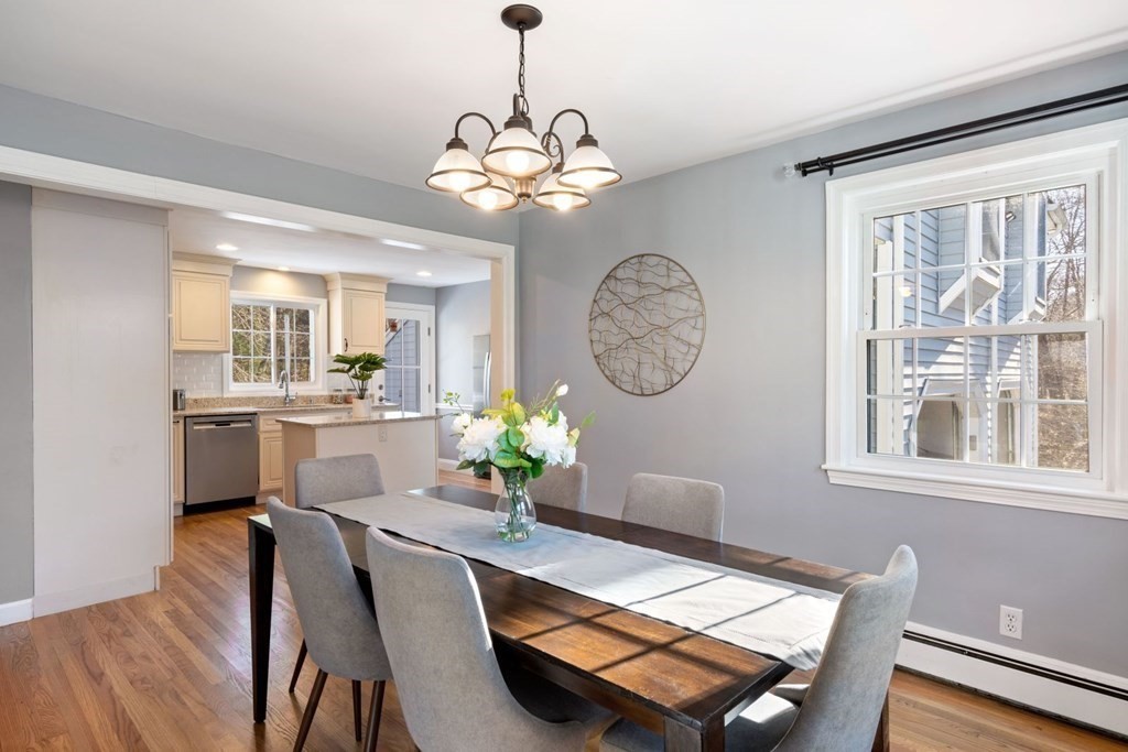 143 Grove Street Lexington, MA 02420 - Photo 12 of 34 a dining room filled chandelier and wooden floor