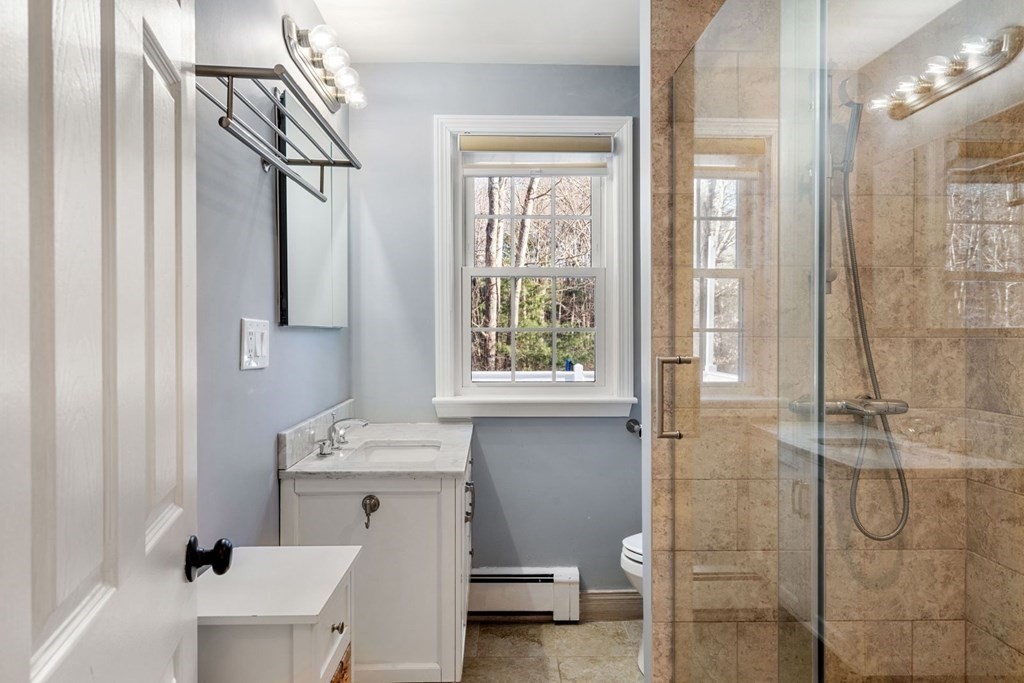 143 Grove Street Lexington, MA 02420 - Photo 16 of 34 a bathroom with a sink mirror toilet and shower