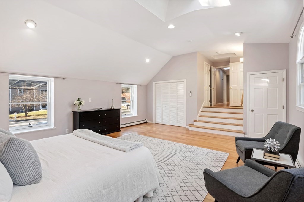 143 Grove Street Lexington, MA 02420 - Photo 19 of 34 a bed room with a bed and a chair
