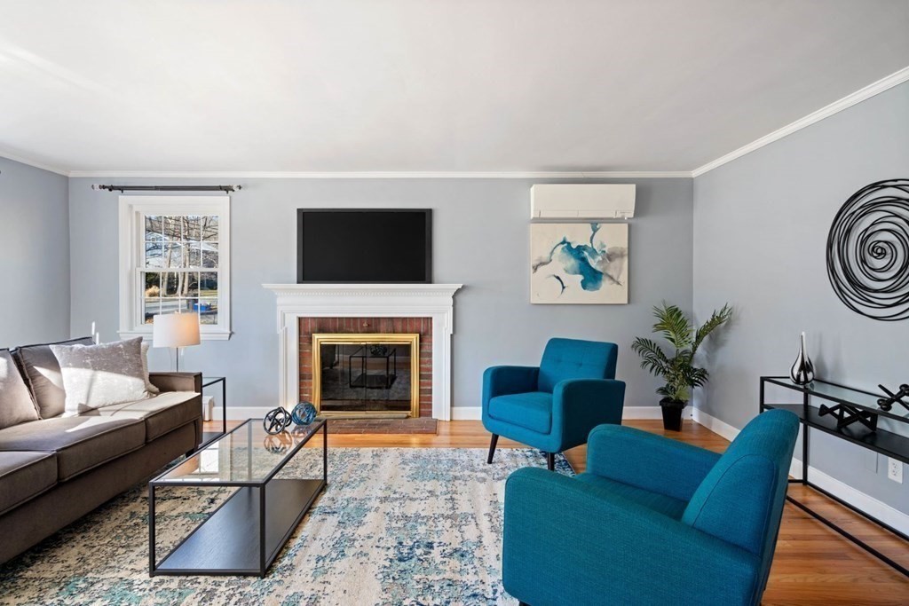 143 Grove Street Lexington, MA 02420 - Photo 5 of 34 a living room with furniture a flat screen tv and a fireplace