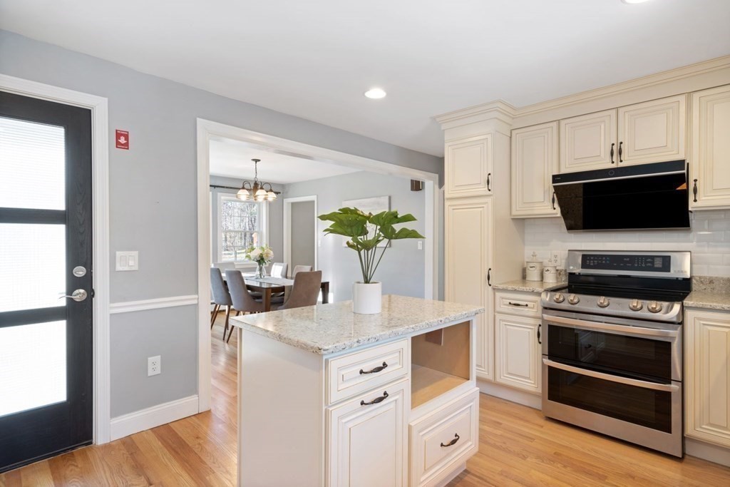 143 Grove Street Lexington, MA 02420 - Photo 10 of 34 a kitchen with white cabinets and stainless steel appliances