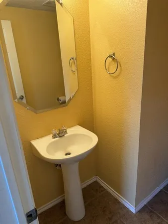 a white toilet sitting next to a small sink