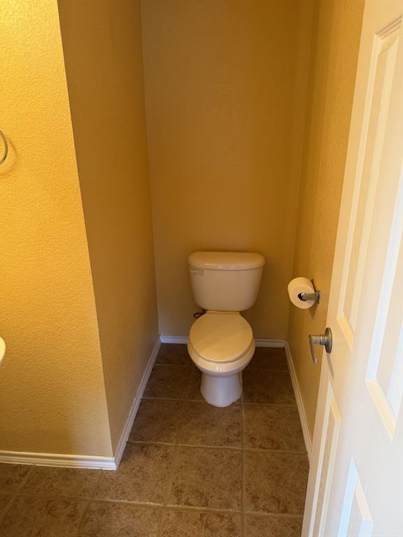 6505 Rienzi Drive Greenville, TX 75402 - Photo 16 of 40 a white toilet sitting next to a small sink