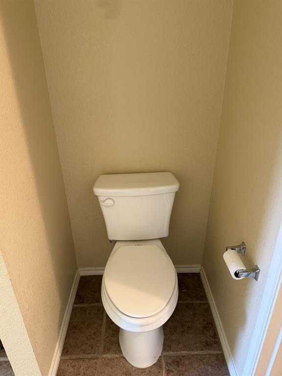 6505 Rienzi Drive Greenville, TX 75402 - Photo 20 of 40 a white toilet sitting next to a white wall