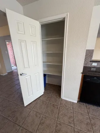 a view of a refrigerator with wooden cabinets