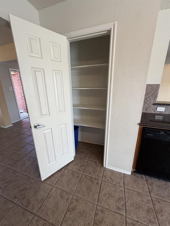 6505 Rienzi Drive Greenville, TX 75402 - Photo 6 of 40 a view of an empty room with cabinet and stairs