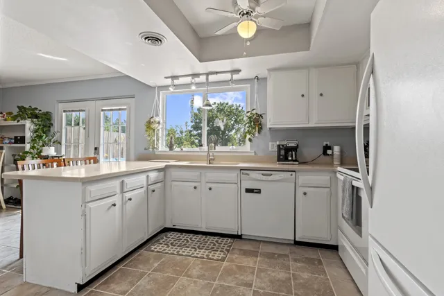 a kitchen with a sink cabinets and window
