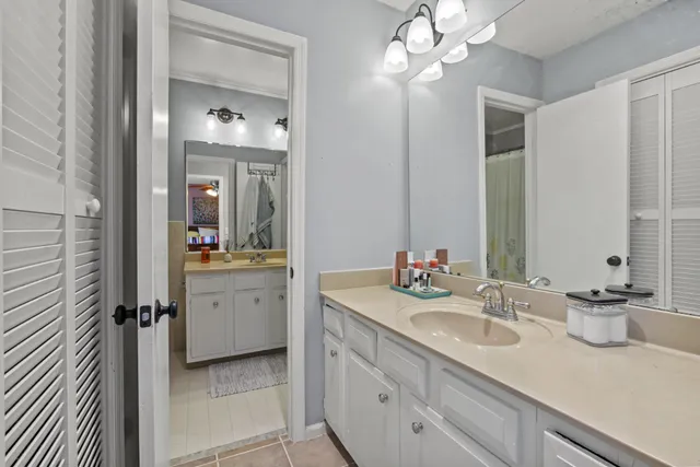 a bathroom with a sink vanity granite and a mirror
