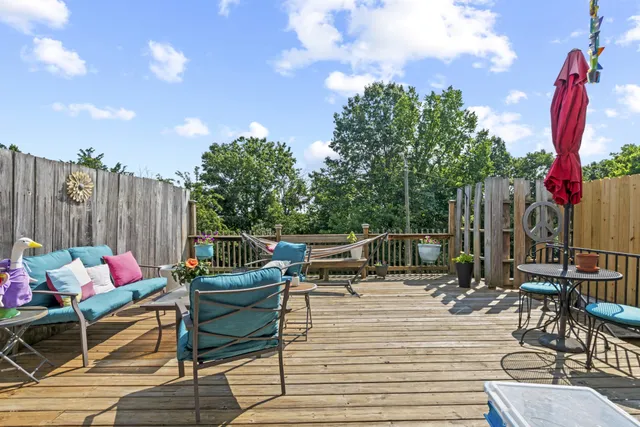 a backyard of a house with table and chairs