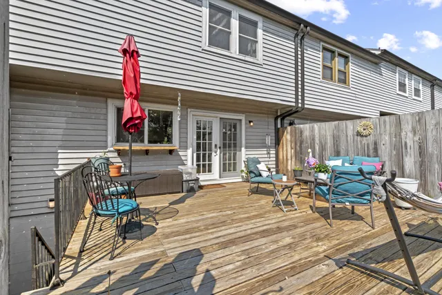 a group of people sitting on a table and chairs