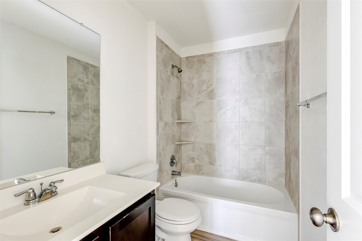 545 Greatest Gift Way Jarrell, TX 76537 - Photo 26 of 34 Bathroom featuring vanity and tub / shower combination