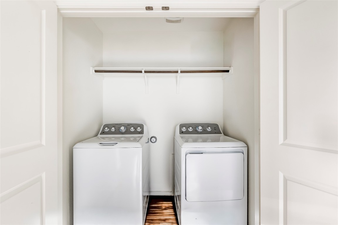 545 Greatest Gift Way Jarrell, TX 76537 - Photo 28 of 34 Laundry room with washing machine and clothes dryer and wood finished floors