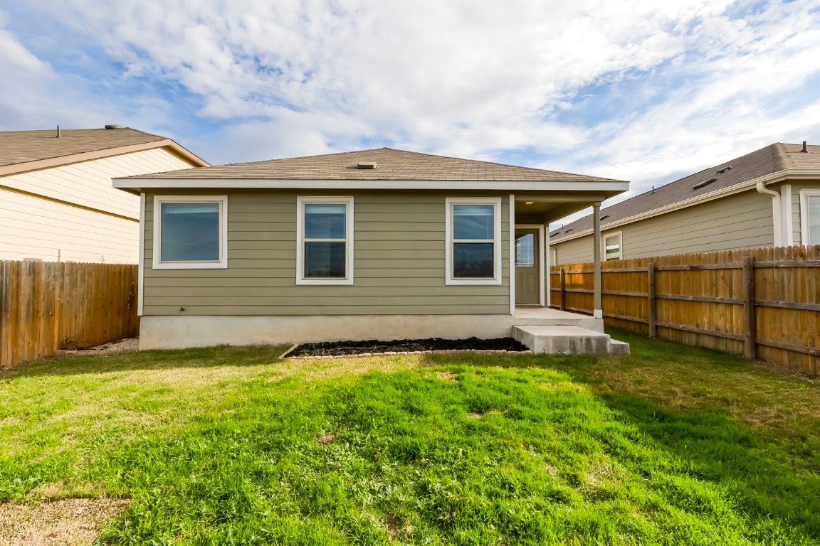 545 Greatest Gift Way Jarrell, TX 76537 - Photo 30 of 34 Rear view of house with a fenced backyard and roof with shingles