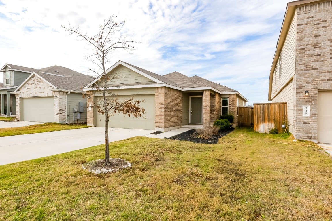 545 Greatest Gift Way Jarrell, TX 76537 - Photo 3 of 34 View of front of house with driveway, a garage, and brick siding