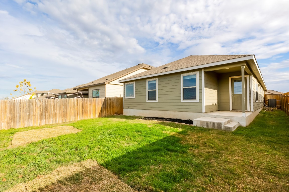 545 Greatest Gift Way Jarrell, TX 76537 - Photo 32 of 34 Back of property featuring a fenced backyard and a patio area