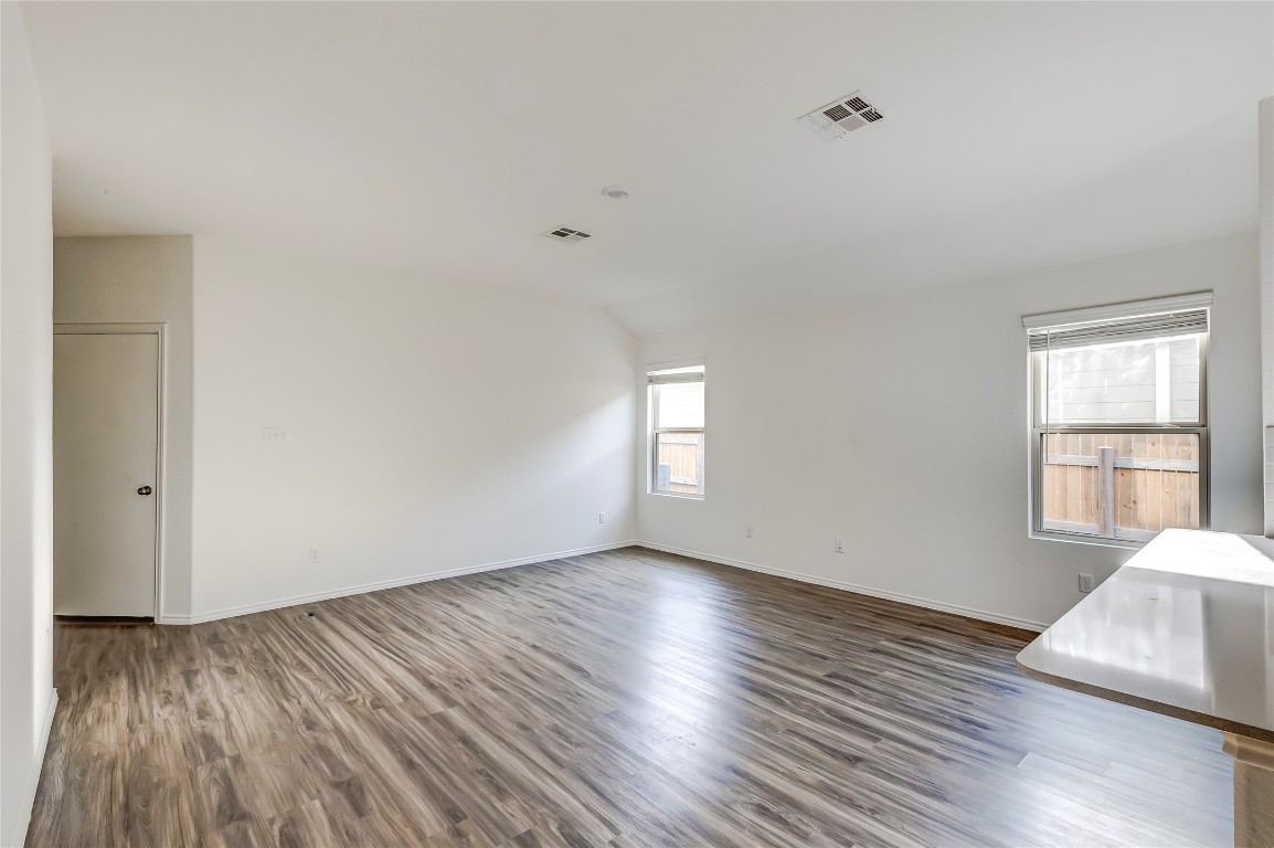 545 Greatest Gift Way Jarrell, TX 76537 - Photo 10 of 34 Empty room with dark wood-style flooring and baseboards