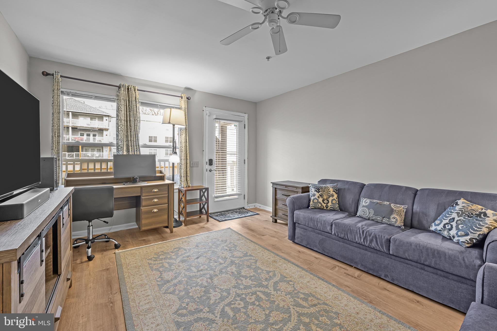 800 Waters Edge Drive Newark, DE 19702 - Photo 7 of 20 a living room with furniture and a flat screen tv