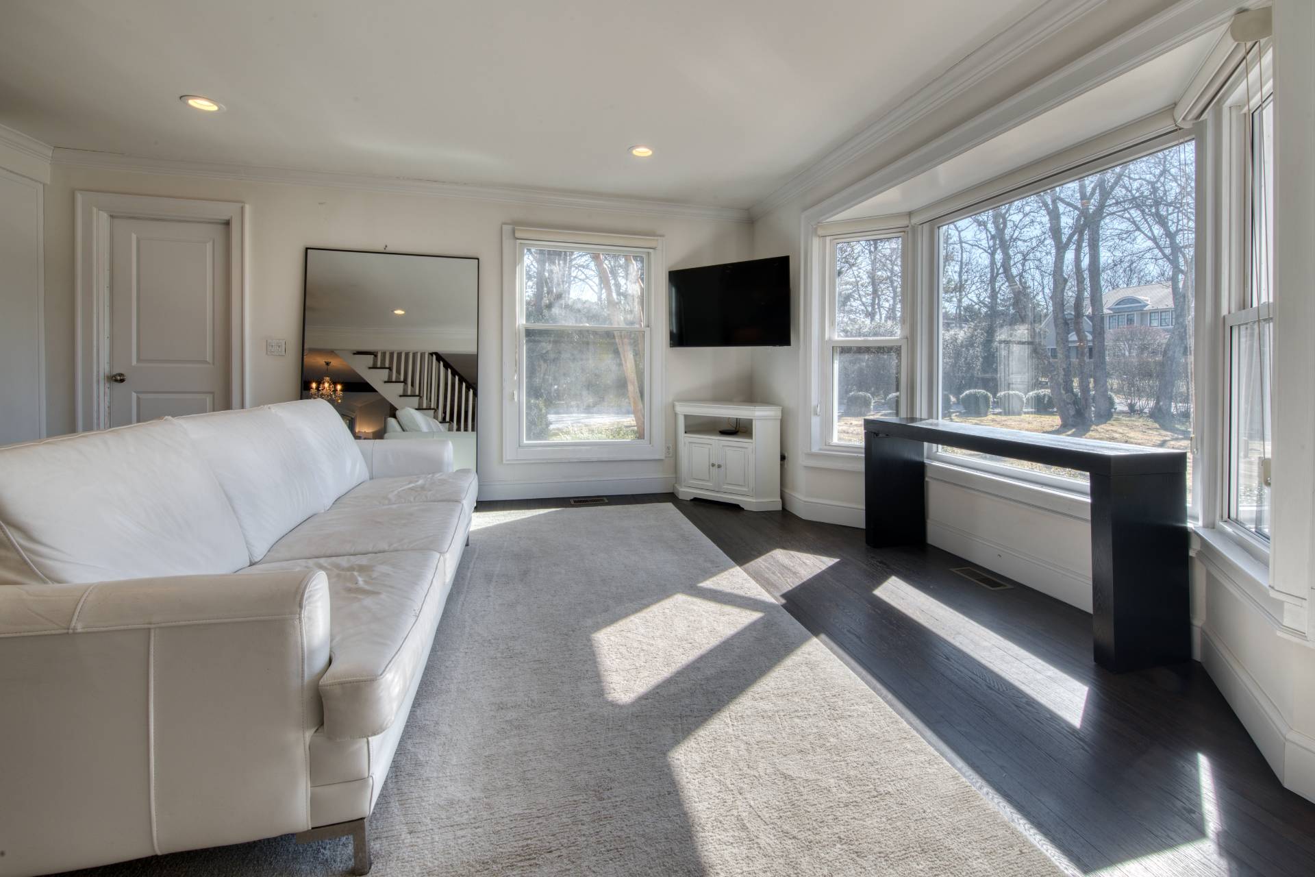 59 Dundee Lane Southampton, NY 11968 - Photo 5 of 10 a living room with furniture a flat screen tv and a large window