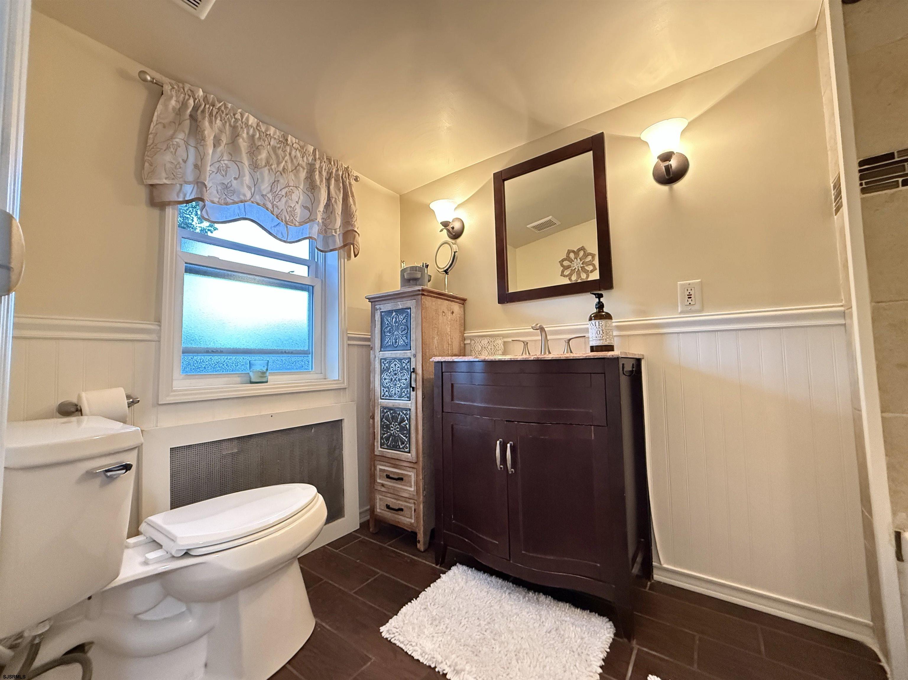 605 Shore Road Linwood, NJ 08221 - Photo 52 of 99 a bathroom with a toilet a sink and a mirror