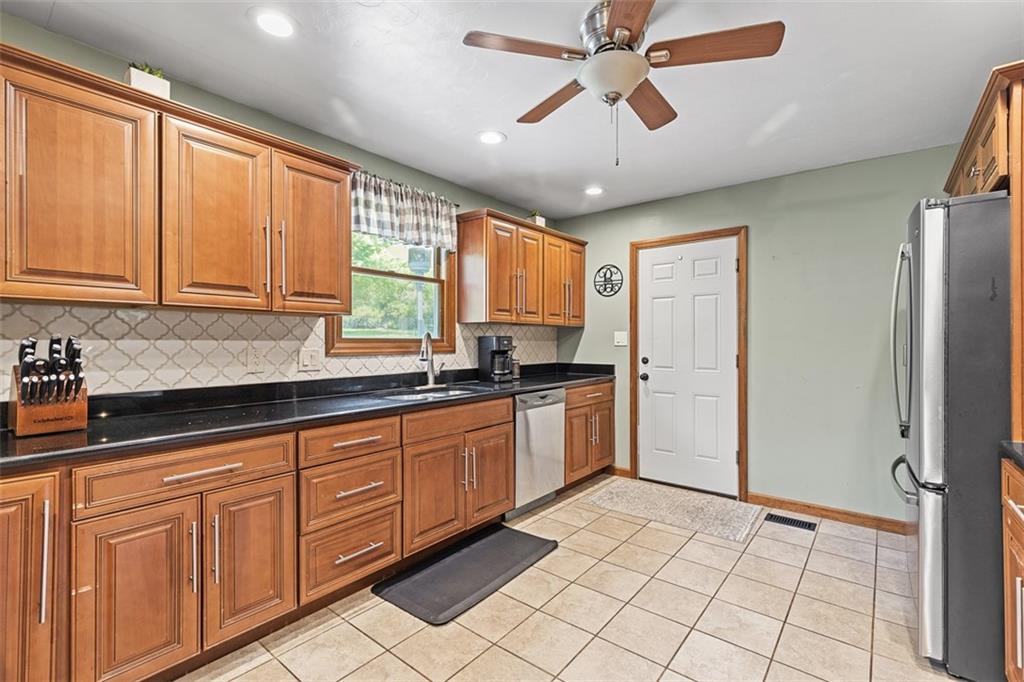 381 Golden Grove Road Baden, PA 15005 - Photo 11 of 38 a kitchen with stainless steel appliances granite countertop a refrigerator and a sink