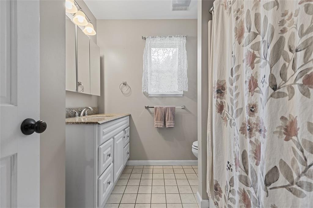 381 Golden Grove Road Baden, PA 15005 - Photo 16 of 38 a bathroom with a sink a toilet and shower