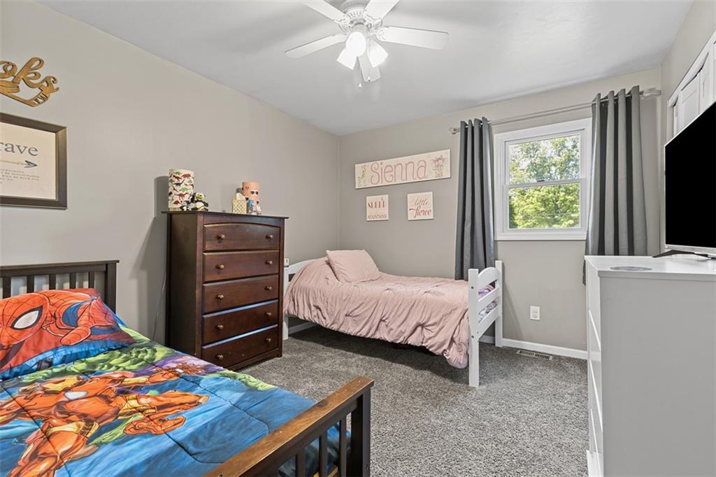 381 Golden Grove Road Baden, PA 15005 - Photo 17 of 38 a bedroom with a bed and a flat tv screen on dresser