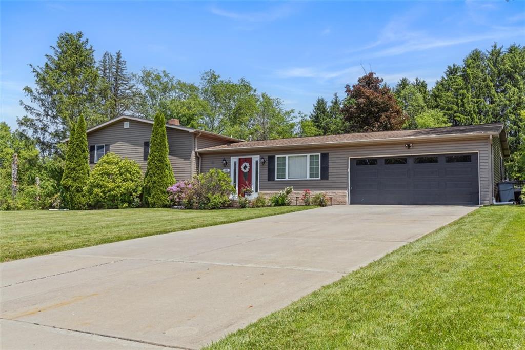 381 Golden Grove Road Baden, PA 15005 - Photo 2 of 38 a front view of a house with a yard and garage