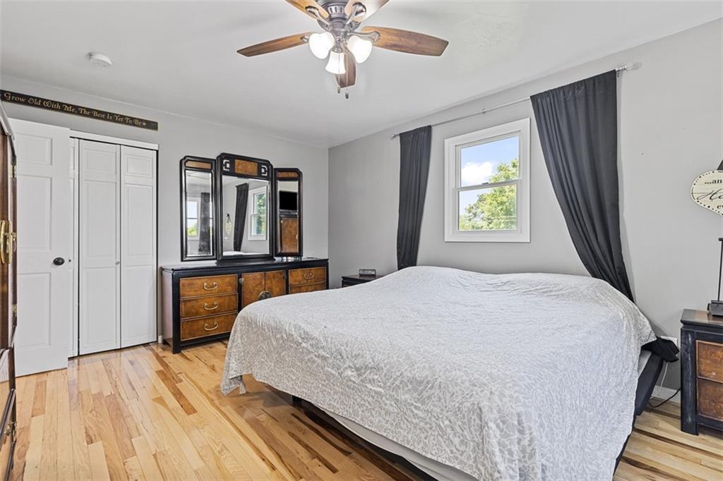 381 Golden Grove Road Baden, PA 15005 - Photo 21 of 38 a bedroom with a large bed and a chandelier