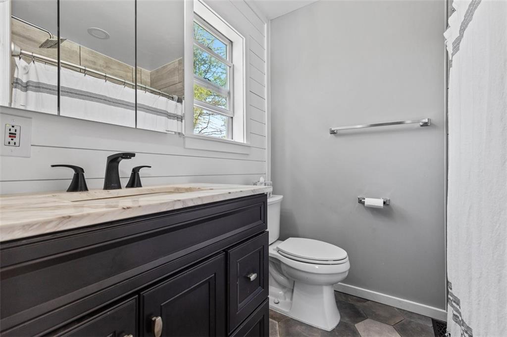 381 Golden Grove Road Baden, PA 15005 - Photo 22 of 38 a bathroom with a toilet a sink and mirror