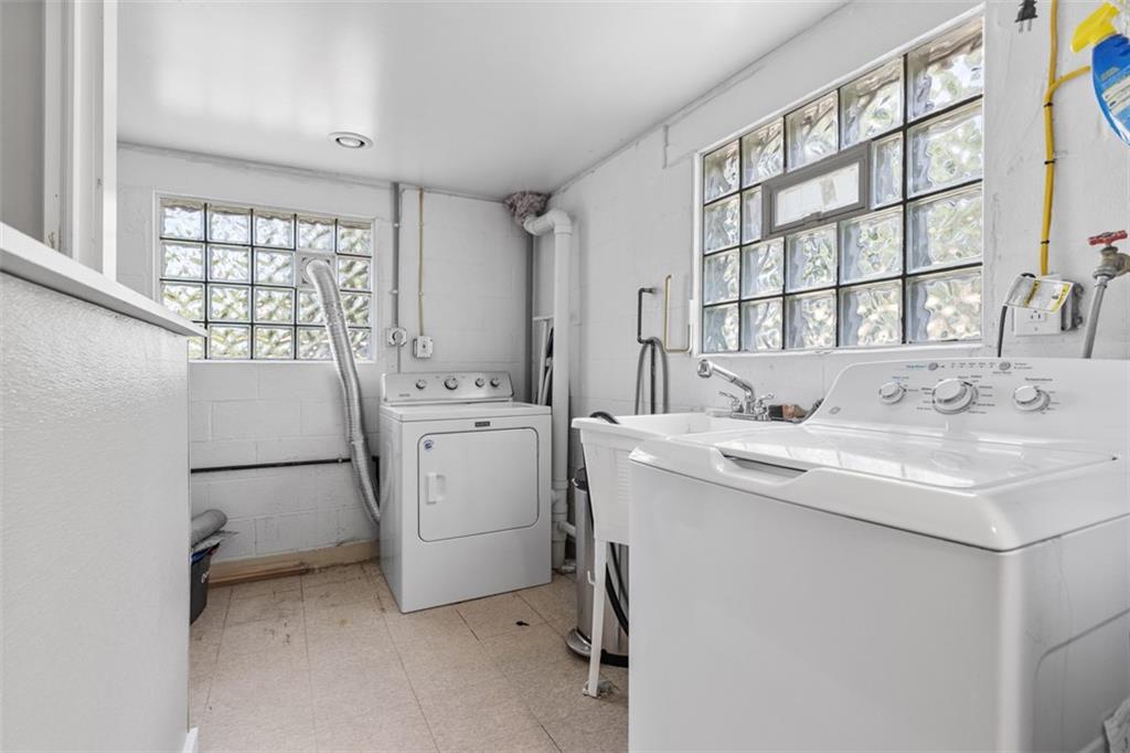 381 Golden Grove Road Baden, PA 15005 - Photo 27 of 38 a utility room with cabinets washer and dryer