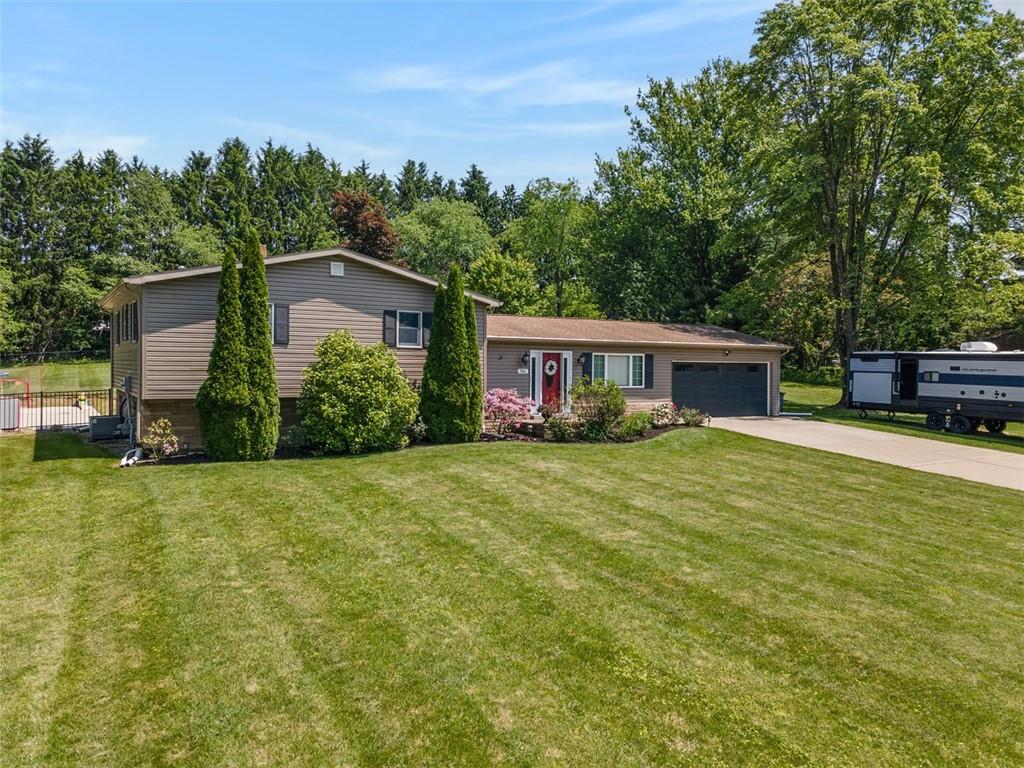 381 Golden Grove Road Baden, PA 15005 - Photo 3 of 38 a front view of a house with a garden