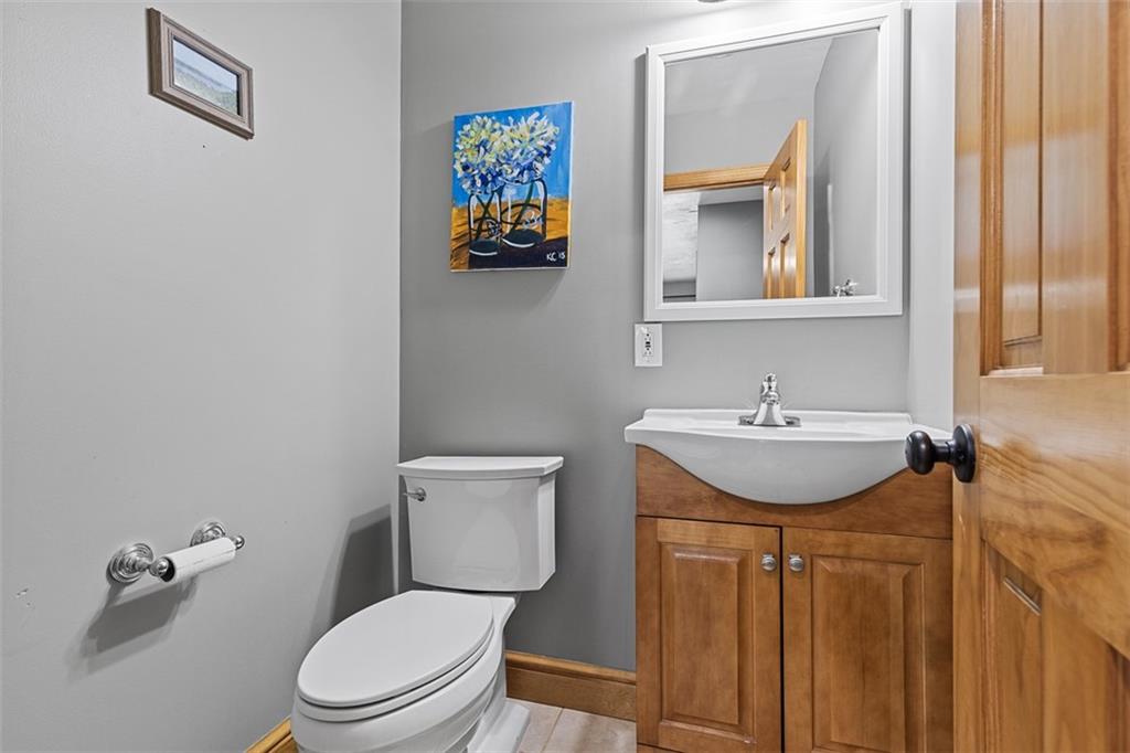 381 Golden Grove Road Baden, PA 15005 - Photo 9 of 38 a bathroom with a toilet sink and mirror
