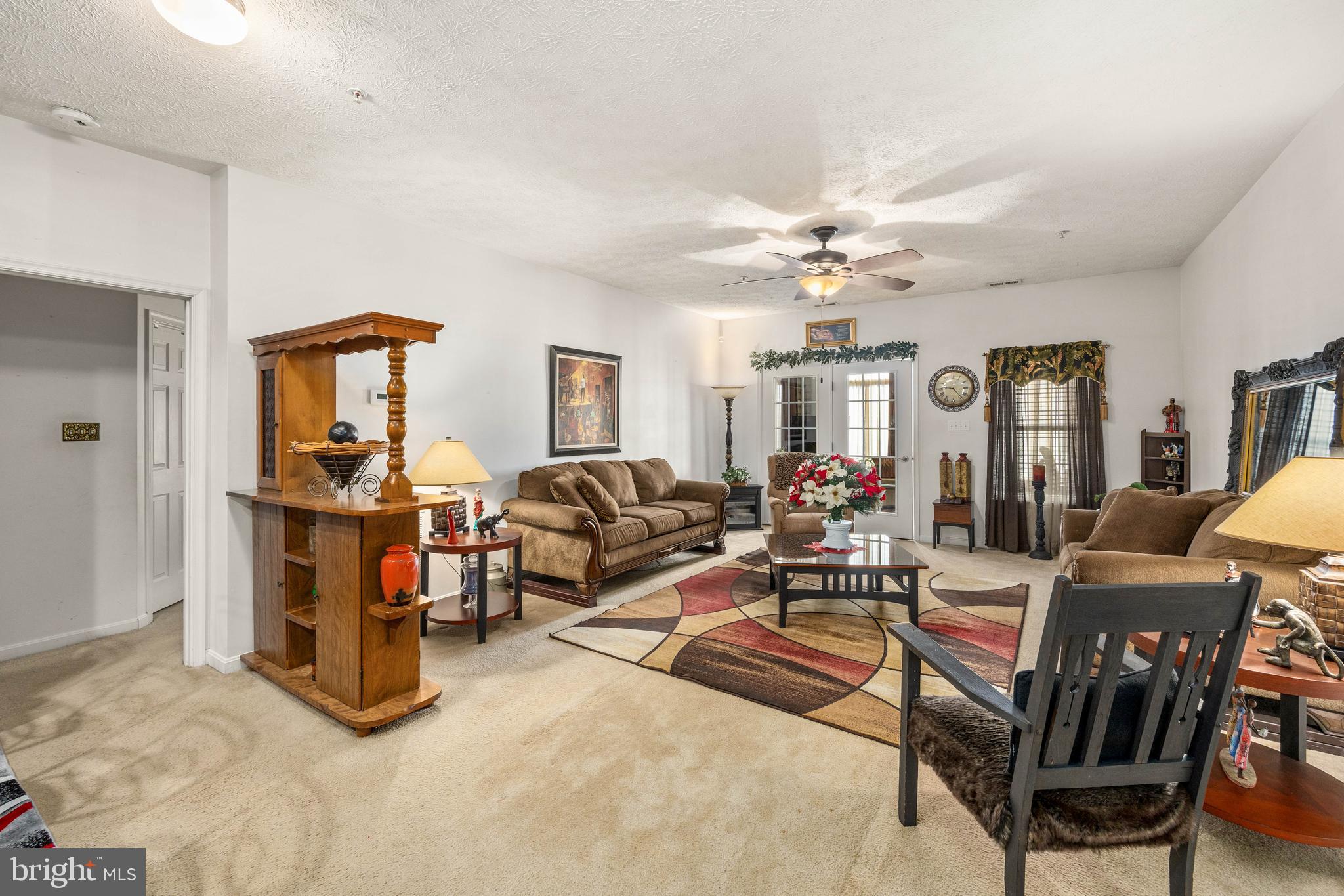 9529 Wedge Way Delmar, MD 21875 - Photo 13 of 39 a living room with furniture a chandelier fan and a window
